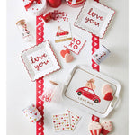 Valentine's Day-themed tableware and decor items on a white background