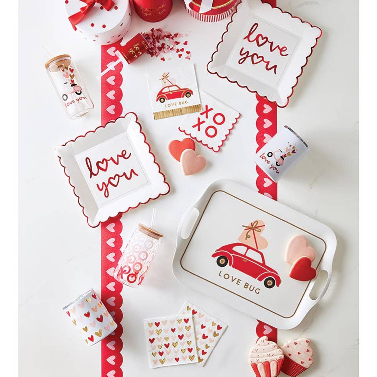 Valentine's Day-themed tableware and decor items on a white background