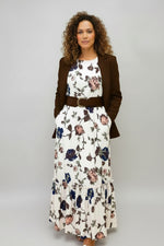 Woman wearing a floral dress on a beige background