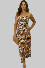 Woman wearing a floral dress with a plain background